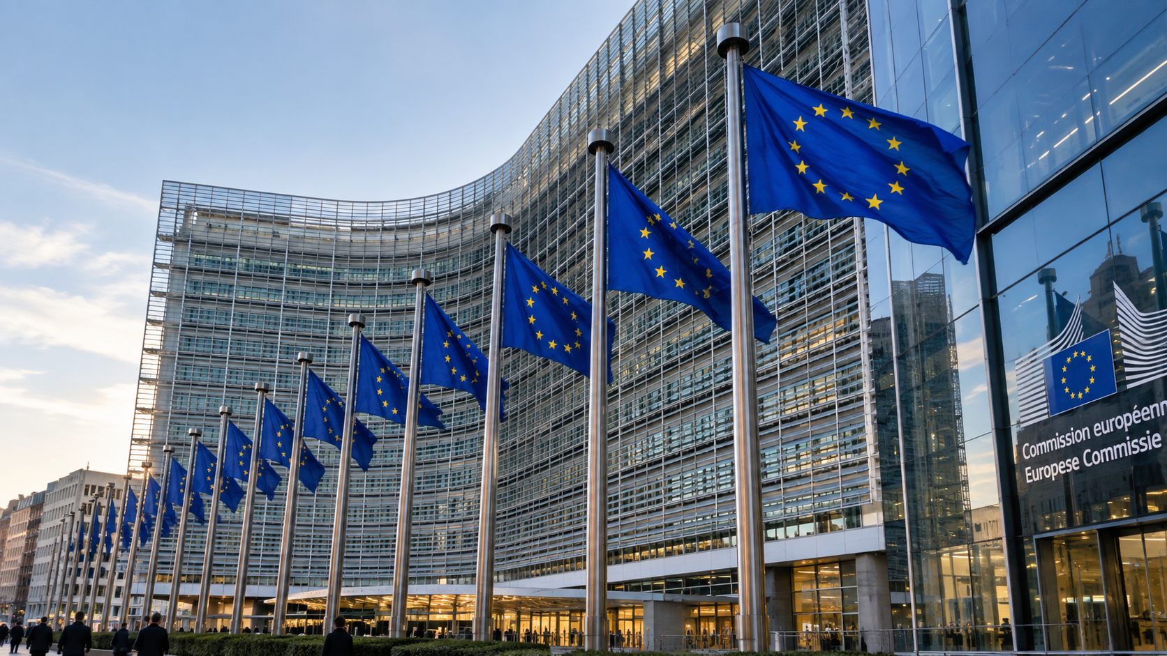 European Commission building in Brussels with a row of EU flags in front