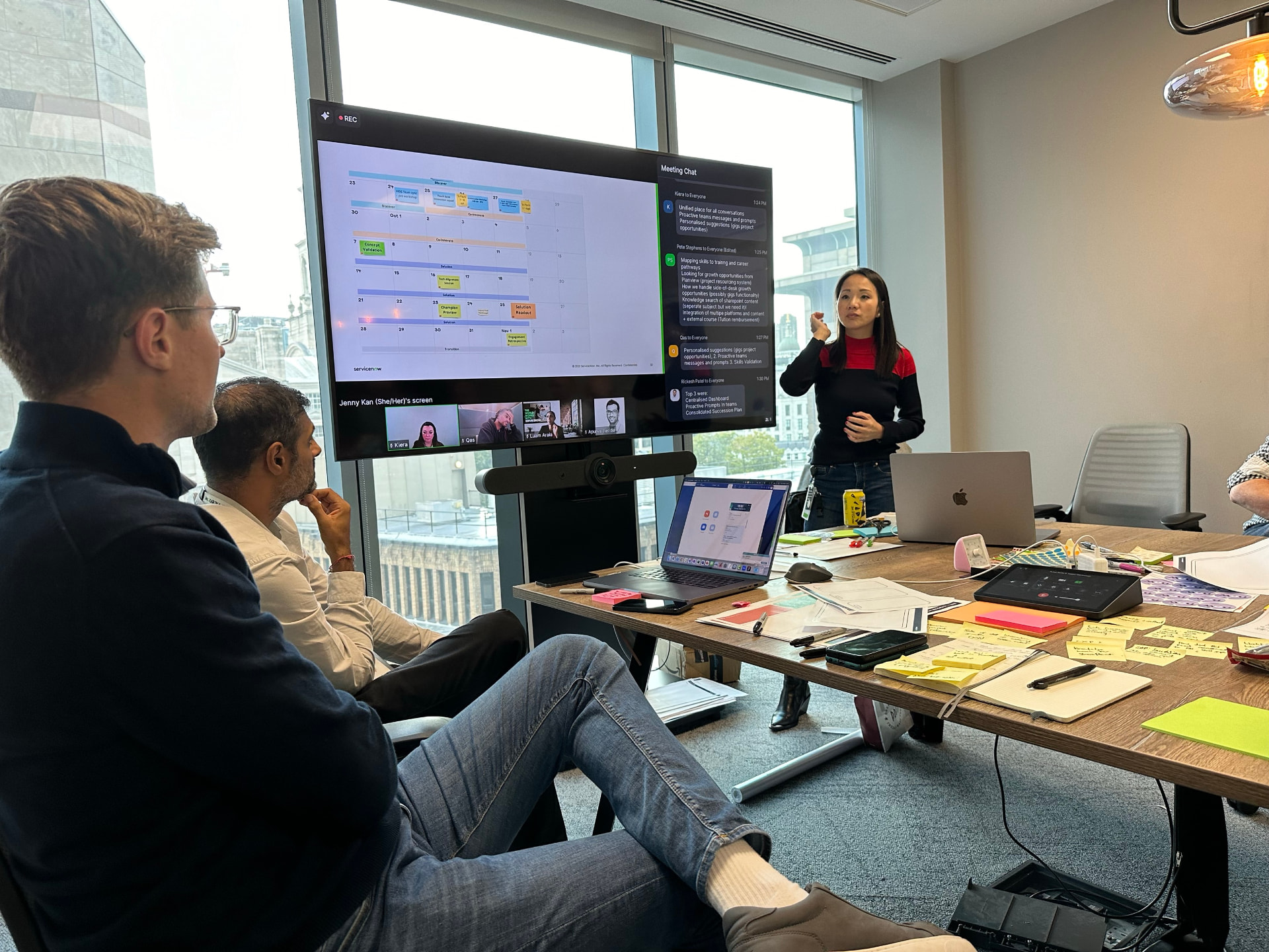 Jenny Kan facilitating a co-creation workshop with the Aviva team around a roadmap on screen